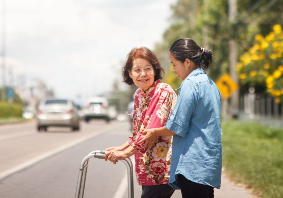 31397243 - senior woman using a walker cross street