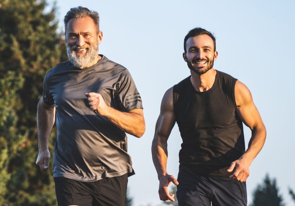 The,Happy,Father,And,A,Son,Running,On,A,Park