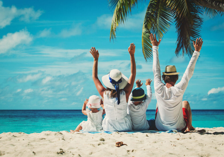 Happy,Family,With,Two,Kids,Hands,Up,On,The,Beach